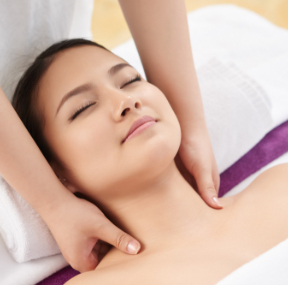 A therapist applying skin care treatment during a full body massage, promoting rejuvenation and glow at our Islamabad spa.